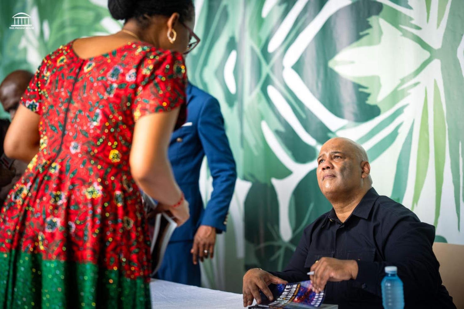 Dr Glenn signing a book